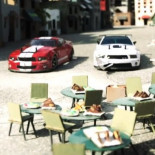 Carrera de coches radiocontrol a través de una ciudad hecha enteramente de cartón